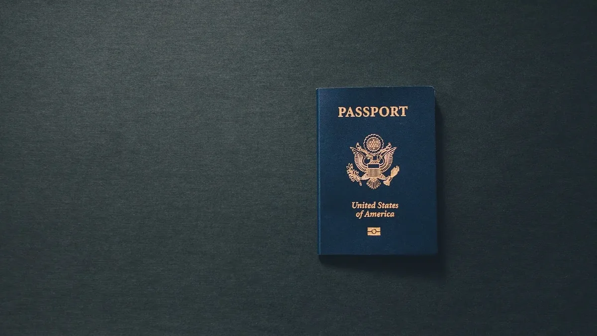 A blue United States passport with gold lettering and a gold seal.
