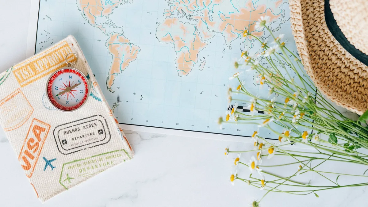 A map, a straw hat, and a passport with a visa stamp.